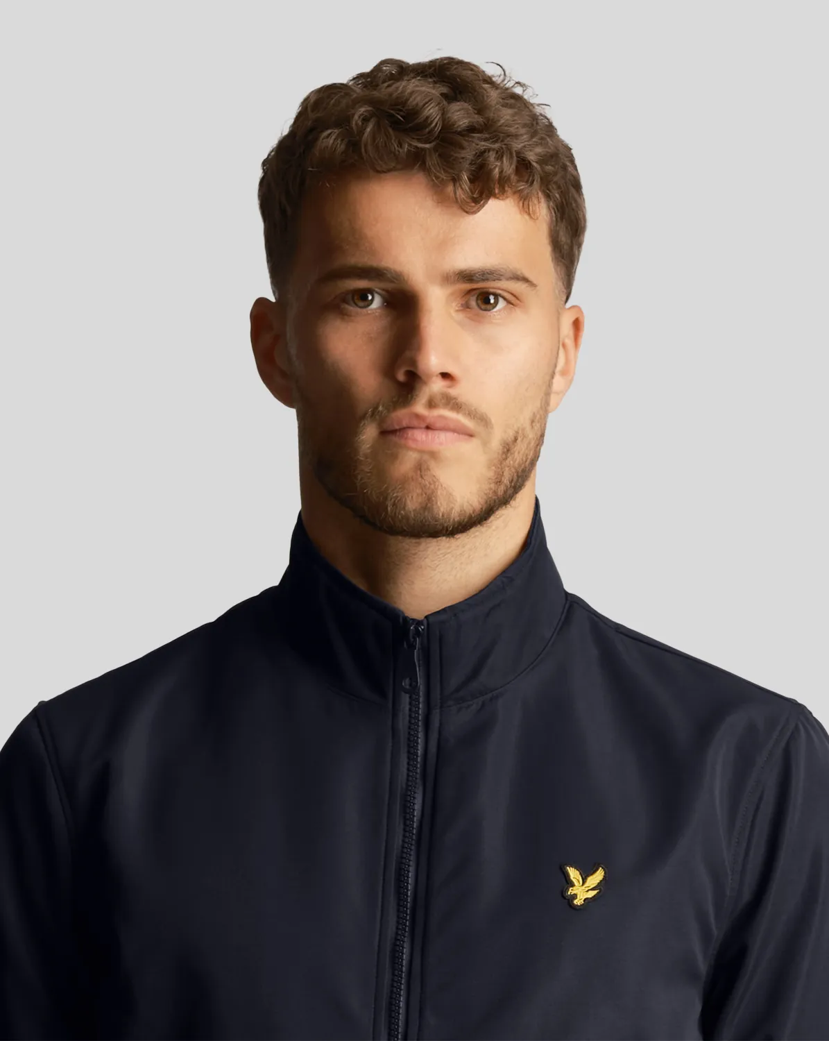 Bomber blu in softshell con logo aquila gialla ricamata sul petto