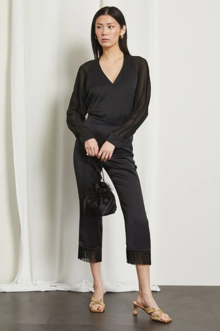 Pantaloni con frange al fondo
